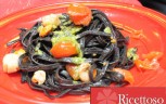 Tagliolini neri alle capesante profumati con pesto agli agrumi
